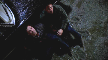 Dean gets Sam outside next to the Impala.